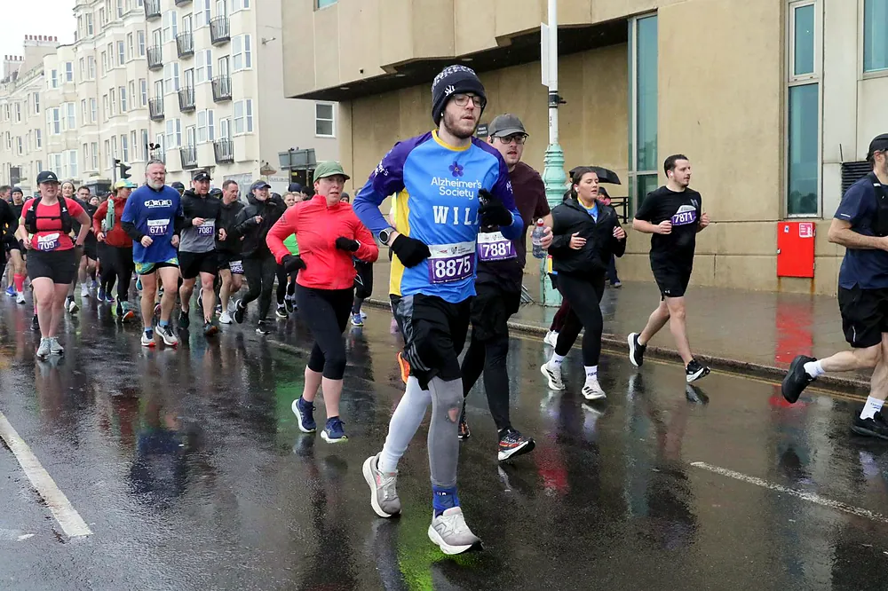 William running along Brighton seafront in an Alzheimer's Society shirt during the half marathon